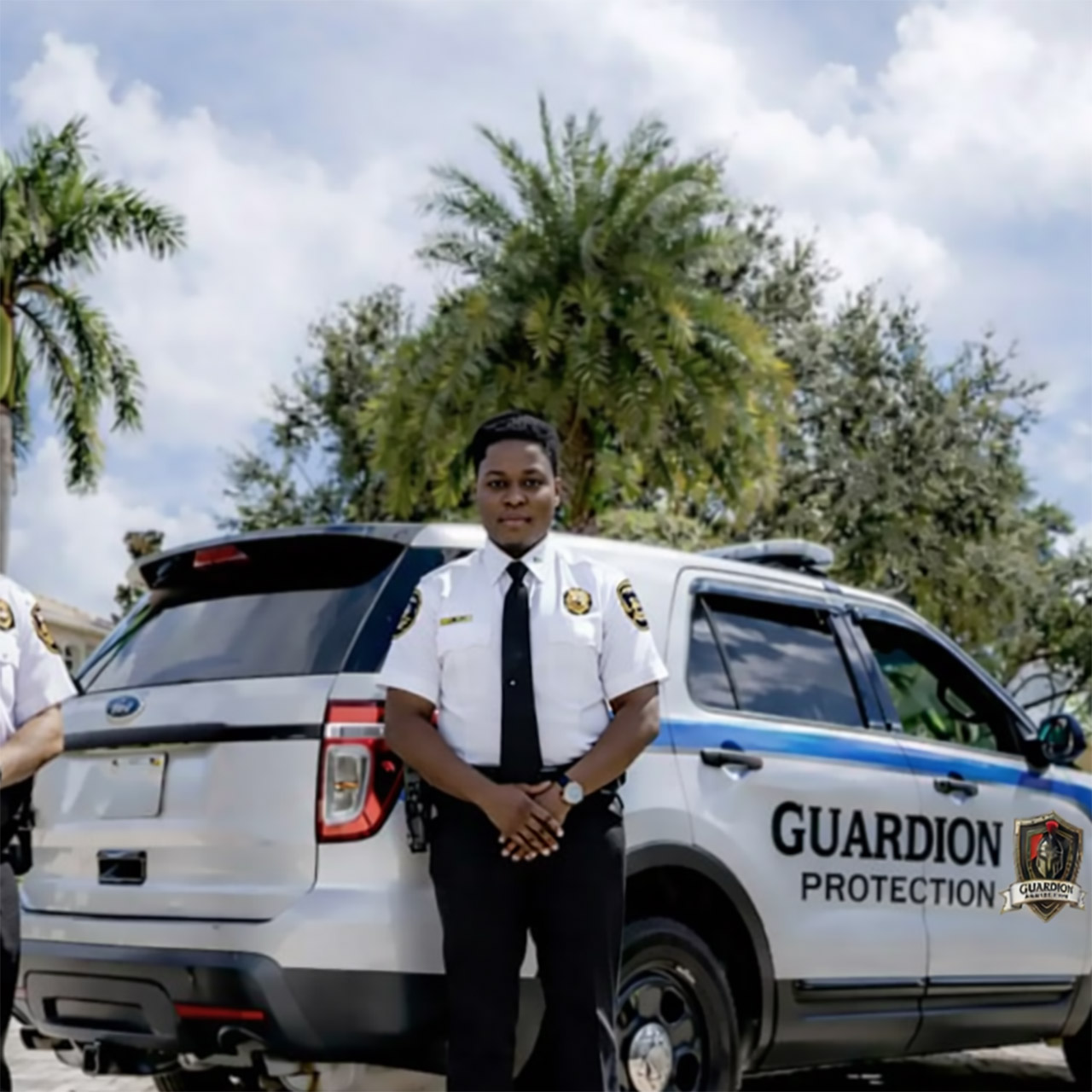 Guardion Protection mobile patrol services featuring a uniformed officer standing with a branded security vehicle for residential and business patrol.